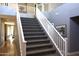 Carpeted staircase with white railing, leading to the upper level with neutral grey walls and elegant trim details at 8920 S 40Th Ln, Laveen, AZ 85339