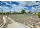 Outdoor basketball court surrounded by rocks and grass at 9431 E Coralbell Ave # Ofc, Mesa, AZ 85208