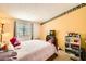 Comfortable bedroom with decorative wall trim, window, and plush bedding at 9431 E Coralbell Ave # Ofc, Mesa, AZ 85208