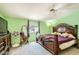 Bedroom features a decorative headboard, ceiling fan, and ample natural light at 9431 E Coralbell Ave # Ofc, Mesa, AZ 85208