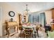 Cozy dining room with a round table, decorative hutch, and chandelier lighting at 9431 E Coralbell Ave # Ofc, Mesa, AZ 85208