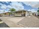 Single-story home featuring a covered carport, storage, and low-maintenance desert landscaping at 9431 E Coralbell Ave # Ofc, Mesa, AZ 85208
