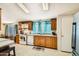 Bright kitchen featuring wood cabinetry, white appliances, and neutral countertops at 9431 E Coralbell Ave # Ofc, Mesa, AZ 85208