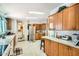 Spacious kitchen showcasing wood cabinets, white countertops, and stainless steel refrigerator at 9431 E Coralbell Ave # Ofc, Mesa, AZ 85208