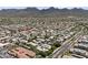 Aerial shot of a residential community with tile roofs, lush landscaping, and mountain views at 9550 E Thunderbird Rd # 214, Scottsdale, AZ 85260