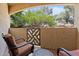 Relaxing outdoor balcony with comfortable seating and views of mature trees, perfect for enjoying the fresh air at 9550 E Thunderbird Rd # 214, Scottsdale, AZ 85260