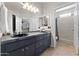 Bathroom with dual sinks, granite countertop, large mirror and walk-in shower at 9550 E Thunderbird Rd # 214, Scottsdale, AZ 85260