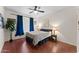 Serene bedroom with a ceiling fan, hardwood floors, and ample natural light creating a relaxing atmosphere at 9550 E Thunderbird Rd # 214, Scottsdale, AZ 85260