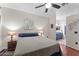 A well-lit bedroom featuring wood floors, ceiling fan, and an ensuite bathroom at 9550 E Thunderbird Rd # 214, Scottsdale, AZ 85260