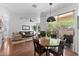 Bright dining area features a wood table and access to outdoor balcony, seamlessly blending indoor and outdoor living at 9550 E Thunderbird Rd # 214, Scottsdale, AZ 85260