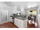 Stylish kitchen with stainless steel appliances, white cabinetry, and an open layout overlooking the dining area at 9550 E Thunderbird Rd # 214, Scottsdale, AZ 85260