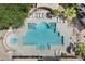 Aerial view of a swimming pool with lounge chairs, a hot tub, and a surrounding patio at 9550 E Thunderbird Rd # 214, Scottsdale, AZ 85260