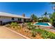Inviting backyard featuring a sparkling pool, lush greenery, and well-maintained landscaping at 9623 N 34Th Pl, Phoenix, AZ 85028