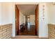Inviting foyer with decorative wood doors, stone flooring, and a view into the home at 9623 N 34Th Pl, Phoenix, AZ 85028
