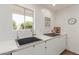 Well-lit kitchen area featuring modern countertops, stainless steel fixtures, and a large window at 9623 N 34Th Pl, Phoenix, AZ 85028