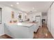 Contemporary white kitchen featuring an island and stainless steel appliances, designed for culinary enthusiasts at 9623 N 34Th Pl, Phoenix, AZ 85028