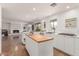 Bright kitchen with a butcher block island and stainless steel appliances, next to living room with fireplace at 9623 N 34Th Pl, Phoenix, AZ 85028
