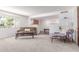 Bright living room with a brick accent wall, plush seating, and open layout, perfect for relaxing and entertaining at 9623 N 34Th Pl, Phoenix, AZ 85028