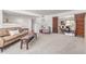 Comfortable living room with neutral carpet, accent furniture, and sliding wooden doors, offering a versatile living space at 9623 N 34Th Pl, Phoenix, AZ 85028