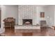 Classic living room with a brick fireplace, vintage organ, and ample natural light, offering a cozy and inviting ambiance at 9623 N 34Th Pl, Phoenix, AZ 85028