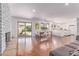 Open-concept living space with a brick fireplace, dining area, and views of the pool, creating a seamless indoor-outdoor flow at 9623 N 34Th Pl, Phoenix, AZ 85028