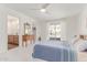 Bright main bedroom features a ceiling fan, ensuite bathroom, dresser, and sliding glass doors to the patio at 9623 N 34Th Pl, Phoenix, AZ 85028