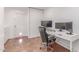 Bright office space featuring modern desk, dual monitors, and comfortable office chair with a convenient pet door at 9623 N 34Th Pl, Phoenix, AZ 85028