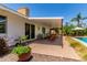 Outdoor patio with comfortable seating, lush foliage, and convenient access to pool at 9623 N 34Th Pl, Phoenix, AZ 85028