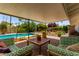 Relaxing covered patio with comfortable seating overlooking a sparkling pool and beautifully landscaped backyard at 9623 N 34Th Pl, Phoenix, AZ 85028