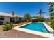 Refreshing pool surrounded by landscaped backyard with patio seating, perfect for outdoor relaxation at 9623 N 34Th Pl, Phoenix, AZ 85028