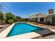 Inviting backyard pool area with an umbrella, comfortable seating and lush landscaping at 9623 N 34Th Pl, Phoenix, AZ 85028