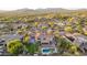 Aerial view of a desert community with a home featuring a basketball court, pool and lush backyard at 9753 E Suncrest Rd, Scottsdale, AZ 85262