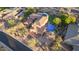 Aerial view of a custom home with a tile roof, pool, lush backyard, and three-car garage at 9753 E Suncrest Rd, Scottsdale, AZ 85262