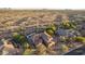 Aerial view of a custom home with a pool, landscaped backyard, and desert landscape backdrop at 9753 E Suncrest Rd, Scottsdale, AZ 85262