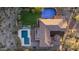 Aerial view of a backyard with a pool, basketball court, putting green, and patio seating at 9753 E Suncrest Rd, Scottsdale, AZ 85262
