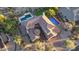 Aerial view of a luxury home with a pool, landscaped backyard, and paver driveway at 9753 E Suncrest Rd, Scottsdale, AZ 85262