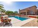 Expansive backyard showcases a pristine pool, lush landscaping, and an outdoor living space for entertaining at 9753 E Suncrest Rd, Scottsdale, AZ 85262