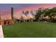 A beautiful landscaped backyard featuring a large grassy area perfect for outdoor activities and enjoying the natural surroundings at 9753 E Suncrest Rd, Scottsdale, AZ 85262