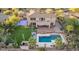 Backyard with pool, outdoor seating, lush grass, putting green, and a basketball court at 9753 E Suncrest Rd, Scottsdale, AZ 85262