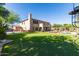This estate has a massive backyard with a sports court, golf green, pool, and covered patio at 9753 E Suncrest Rd, Scottsdale, AZ 85262