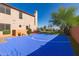 Backyard basketball court with blue surface, red chairs, and lush landscaping in a private setting at 9753 E Suncrest Rd, Scottsdale, AZ 85262