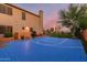 A private basketball court with desert landscaping and mature trees, creating a serene and active outdoor space at 9753 E Suncrest Rd, Scottsdale, AZ 85262