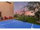 A backyard featuring a basketball court, desert landscaping, mature trees and privacy for an active and private recreational space at 9753 E Suncrest Rd, Scottsdale, AZ 85262