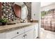 Stylish bathroom with a white vanity, decorative mirror, and a shower featuring wood-look shower curtain at 9753 E Suncrest Rd, Scottsdale, AZ 85262