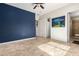 Bright, open bedroom with light tile flooring, a dark accent wall and ensuite bathroom at 9753 E Suncrest Rd, Scottsdale, AZ 85262