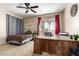 Bright bedroom featuring neutral colors, a ceiling fan, and sliding glass doors for outdoor access and light at 9753 E Suncrest Rd, Scottsdale, AZ 85262