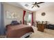Neutral bedroom with a bed, a ceiling fan, world map decor, and sliding glass doors to a patio at 9753 E Suncrest Rd, Scottsdale, AZ 85262