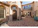 Welcoming courtyard with paver flooring, an arched doorway, and ample natural light at 9753 E Suncrest Rd, Scottsdale, AZ 85262