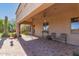 Spacious covered patio with brick flooring, ceiling fans, and comfortable seating area perfect for outdoor relaxation at 9753 E Suncrest Rd, Scottsdale, AZ 85262