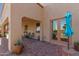 This covered patio includes brick flooring, a grill, and lots of space for outdoor seating and dining at 9753 E Suncrest Rd, Scottsdale, AZ 85262